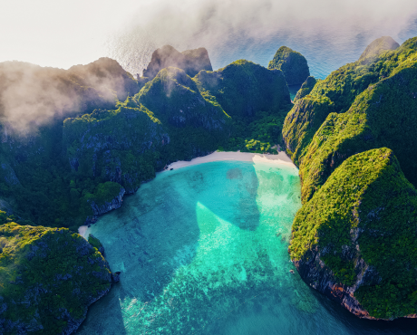 Watch the sunrise at Phi Phi Island. The sky displays a gradient of colors over the Andaman Sea. The peaceful and beautiful atmosphere is the perfect way for travelers to start their day.